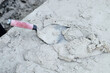 © Rowena Naylor/Stocksy - Bricklayers trowel and cement