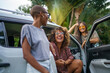 © Jovo Jovanovic/Stocksy - Three friends taking break by talking around car