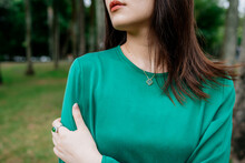 Close Up View Of Woman With Green Clothes And Green Jewely
