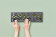 © Yaroslav Danylchenko/Stocksy - Person using keyboard with growing plant