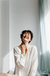 © Tania Cervian/Stocksy - Cheerful young androgynous person laughing with closed eyes