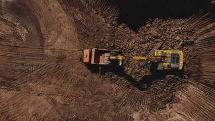 Poster - Excavator during clay mining.  mining in open pit. Aerial view of an opencast for the extraction of clay and limestone. Brick and Tile. Excavator loads clay in dump truck in quarry. 