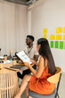© Valentina Barreto/Stocksy - Mixed couple in cowork space