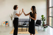 © Valentina Barreto/Stocksy - Businesswomen linked with intertwined threads