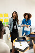 © Valentina Barreto/Stocksy - Mixed group informal business meeting