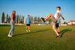 © phoenix021 - Group of people , guys and a girl playing soccer on a field for fun