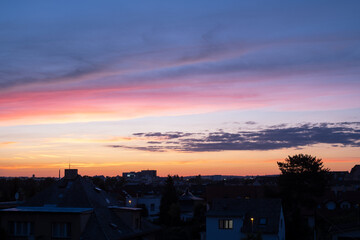 Wall Mural - Majestic sunset at dusk dramatic skyscape on roof top. Amazing clouds with orange light of nature