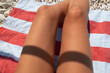 © Sonja Lekovic/Stocksy - tanned sexy legs detail on a beach towel