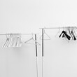 © Simone Wave/Stocksy - Coat hungers on white background