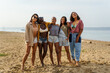 © Jovo Jovanovic/Stocksy - Women having fun while taking group photo at beach