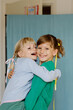 © Tanya Yatsenko/Stocksy - Two happy girls indoors