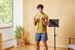 © ALTO IMAGES/Stocksy - Male athlete doing biceps exercise with resistance band