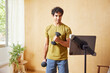 © ALTO IMAGES/Stocksy - Fit man watching tablet and exercising with dumbbells