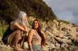 © Alba Vitta/Stocksy - Portrait of happy mother and adult daughter chatting at the beach