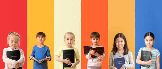 set of children with bible on color background