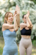 © Andriy Bezuglov/Stocksy - Two young woman doing yoga with crossed hands and closed eyes