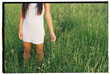 © Berena Alvarez/Stocksy - A young asian girl posing in the field