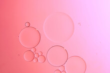 Oil With Bubbles On Coral Background