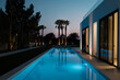 © Malquerida Studio/Stocksy - Luxury villa with pool lighted at night