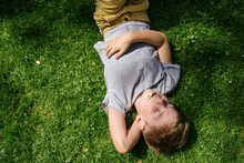 Kid Sleeping On Grass.