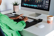 © David Prado/Stocksy - Female trader working on computer in home office
