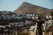 © Lucia Postike/Stocksy - Young woman in front of a beautiful landscape with a mountain
