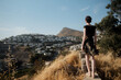 © Lucia Postike/Stocksy - Woman admiring the view of the city from the hill