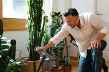 Man Caring For Plants At Home.