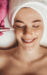 Wall Mural - cosmetologist making procedure microdermabrasion on the face against acne. medical equipment. health