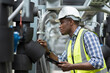 © amorn - Male plumber engineer worker work with digital tablet in sewer pipes area at construction site. African American male engineer worker check or maintenance sewer pipe network system at construction sit