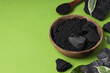 Leinwandbild Motiv Natural charcoal and powdered charcoal on green background