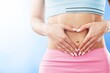 © BillionPhotos.com - Young healthy woman hand made heart shape on her stomach. Concept of good digestive, healthy gut, probiotics, slim fit, gynecology and woman health care.