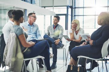 Wall Mural - Modern business people in an informal team building discussion or business talking session. Team leader, manager or supervisor talking to a group of employees or colleagues on new workflow management
