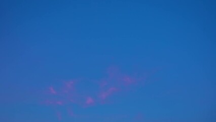 Wall Mural - Low angle shot of movement of thin cirrus cloud in the blue sky at daytime in timelapse.