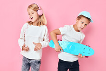 Stylish Little Boy And Cute Girl Smiling And Listening To Music In Headphones Isolated Background