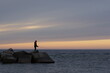 silhouette of a fishman on the beach