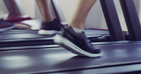 Canvas Print - Active, athletic closeup of trainers, in workout shoes, running on treadmill in sports exercise fitness gym. Group of people exercising a fit and healthy lifestyle, indoors with jogging workout