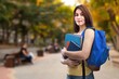 © BillionPhotos.com - Smiling student walking outdoor in a college courtyard outdoor