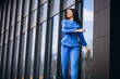 © Petro - Woman in blue sports wear stretching outside the street