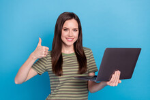 Photo Of Cool Young Brunette Lady Hold Laptop Thumb Up Wear Striped T-shirt Isolated On Blue Color Background