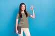 Leinwandbild Motiv Photo of cute young brunette lady hold laptop show okey wear striped t-shirt isolated on blue color background