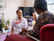 Elderly woman talking with nurse