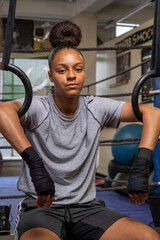 Wall Mural - Young woman exercising at gym, portrait