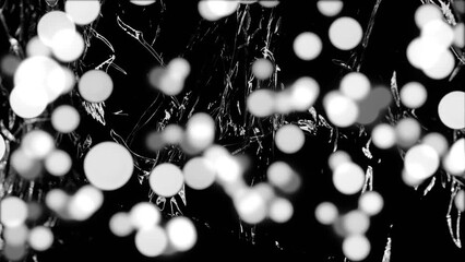 animation of grey and white spots of light over light on moving shiny black plastic