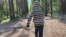Following Happy Little Boy Running Through Summer Forest. Back View.