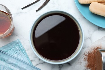 Flat lay composition with coffee and other tiramisu ingredients on white marble table