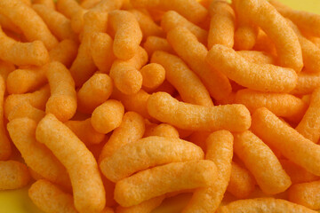 Wall Mural - Tasty cheesy corn puffs as background, closeup