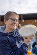 © Gino Gallucci - Grandma smiling showing a bowl with homemade cream