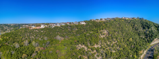 Wall Mural - Austin. Texas- Panoramic view of mansions and villas on top of a slope against the clear blue sky