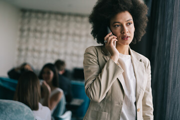 Poster - Beautiful african corporate worker talking on mobile phone